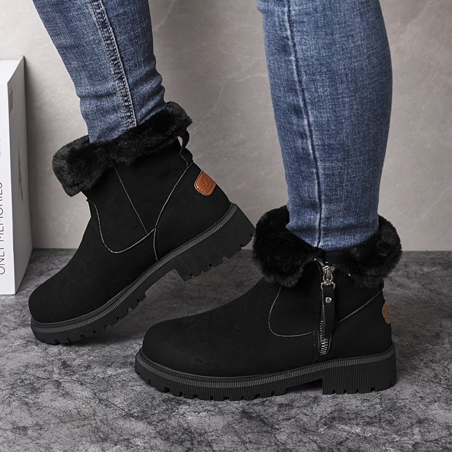 Adaline lug sole ankle boots in black suede, worn with jeans, side profile view