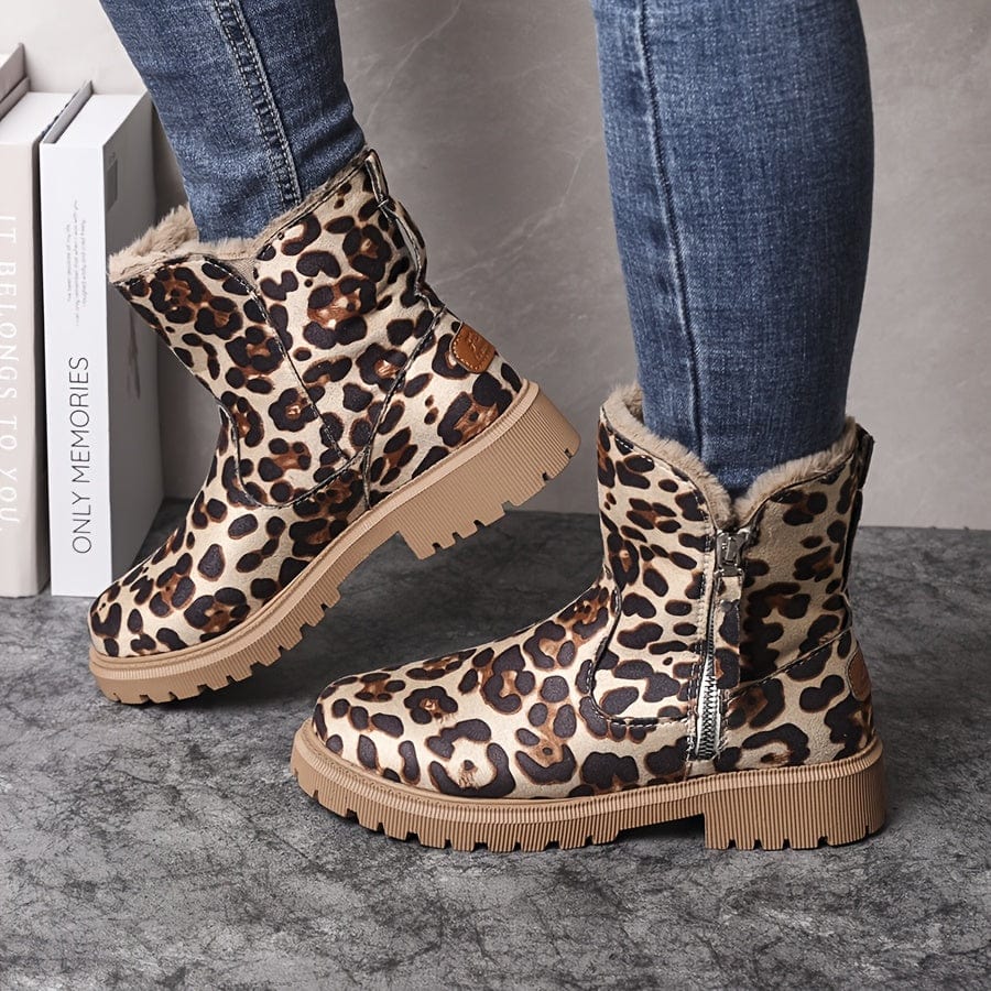 Adaline lug sole ankle boots in leopard print, worn with jeans, side view