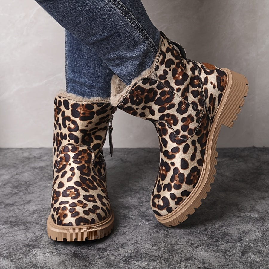 Adaline lug sole ankle boots in leopard print, front three-quarter view worn with jeans