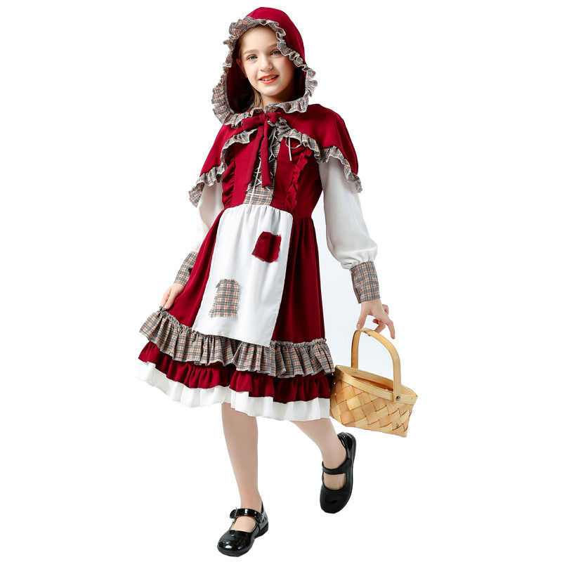 Girl wearing red storybook Halloween costume with hooded capelet, white apron and plaid ruffle hem