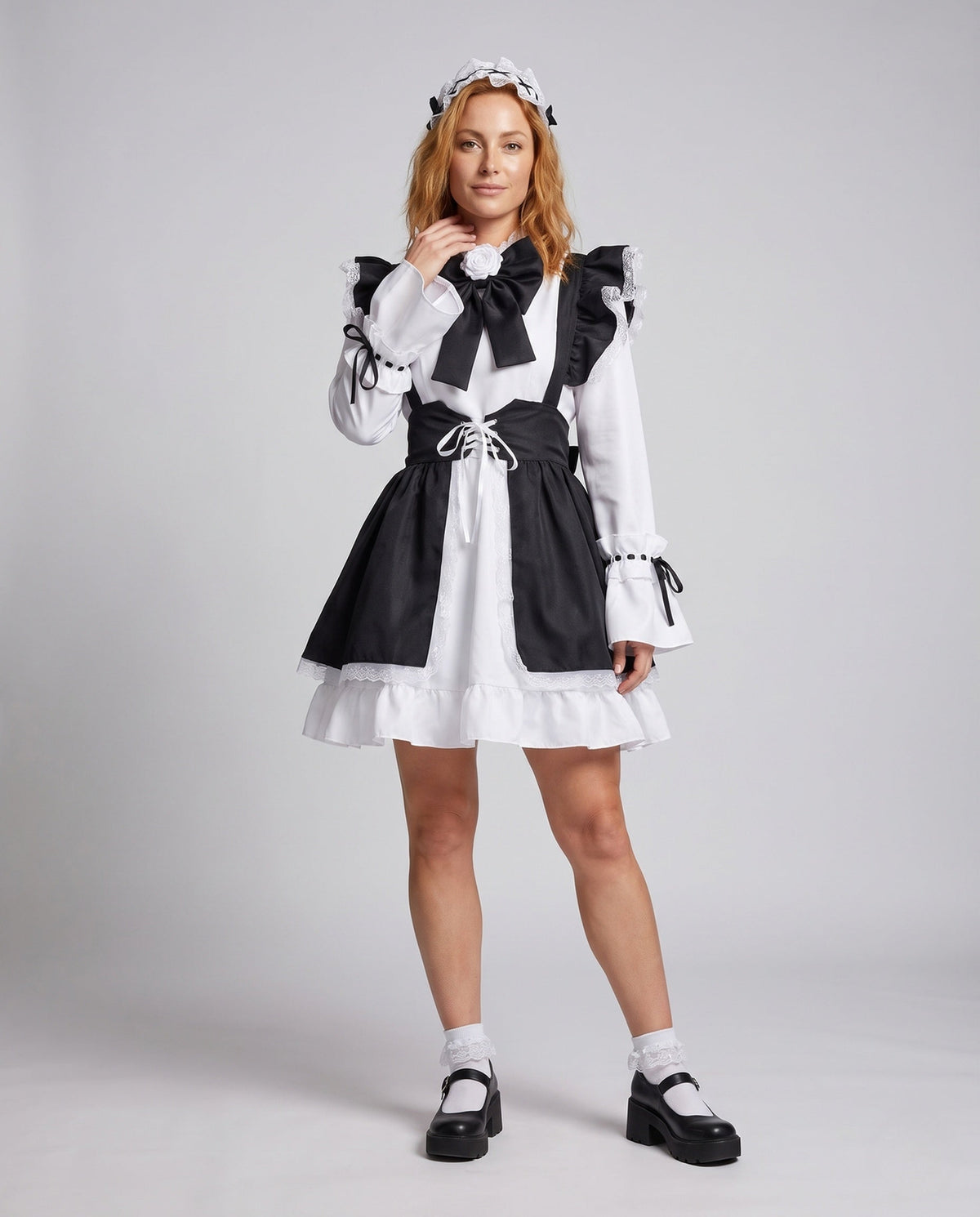 Women's black and white maid Halloween costume with ruffled apron, laced waist and large bow