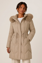 Quilted knee-length puffer jacket for women with faux fur hood and cinched waist