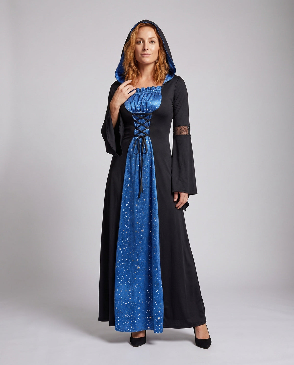 Women's hooded witch costume dress in black with blue star-print panel, lace-up front and bell sleeves