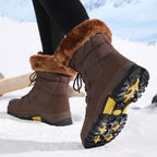 Avyra lace-up snow boots in brown, angled view showing yellow lug sole tread