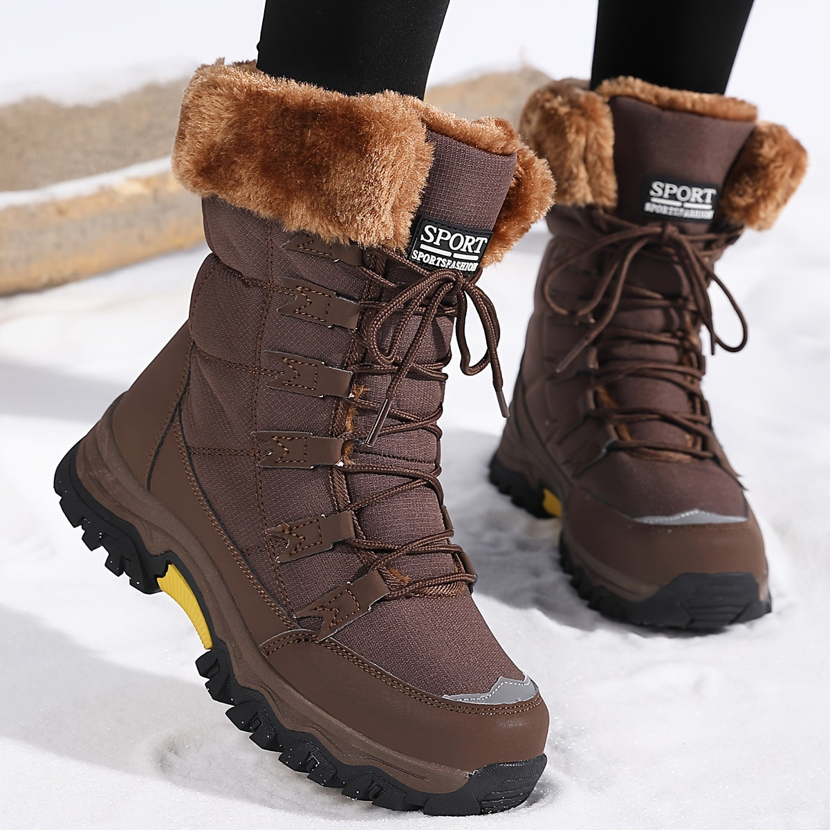 Avyra lace-up snow boots in brown with fur cuff, front view standing in snow