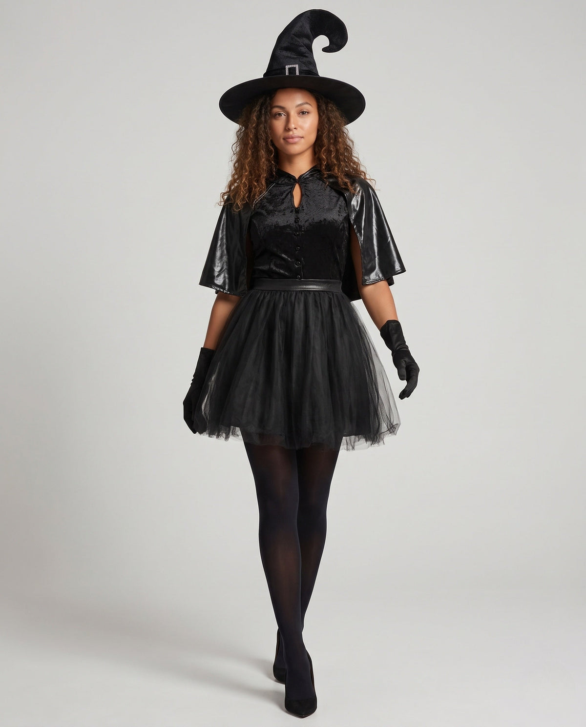 Women's black witch Halloween costume with velvet keyhole bodice, leather-look capelet and tulle skirt