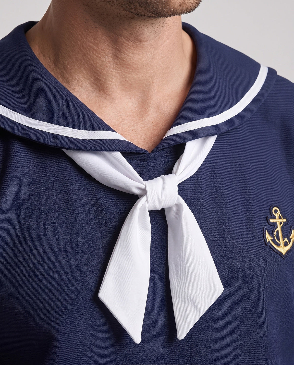 Men's navy sailor Halloween costume with white striped collar, white neckerchief and anchor patch - view 2