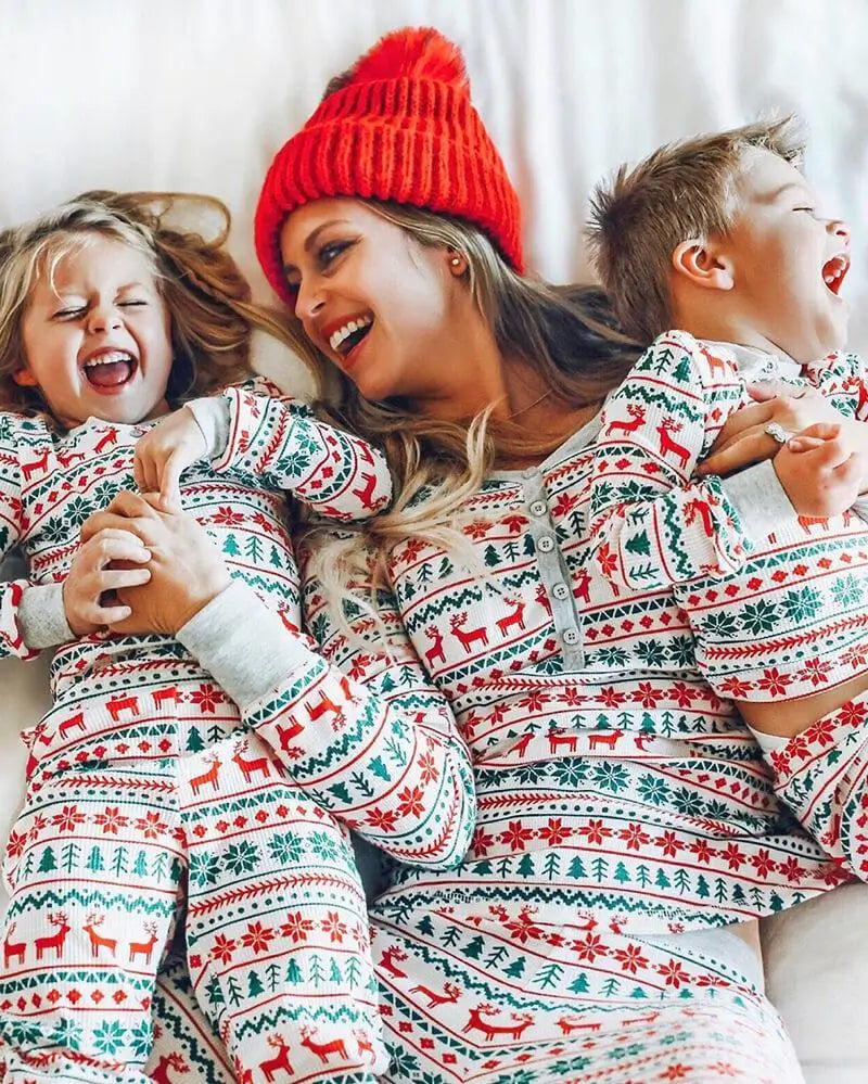 Family wearing matching Fair Isle Christmas pajamas with reindeer print and gray ribbed cuffs - view 7