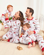 Family wearing matching white Christmas pajamas with Santa sleigh and reindeer print and red trim - view 2