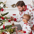 Family wearing matching white Christmas pajamas with Santa sleigh and reindeer print and red trim - view 8