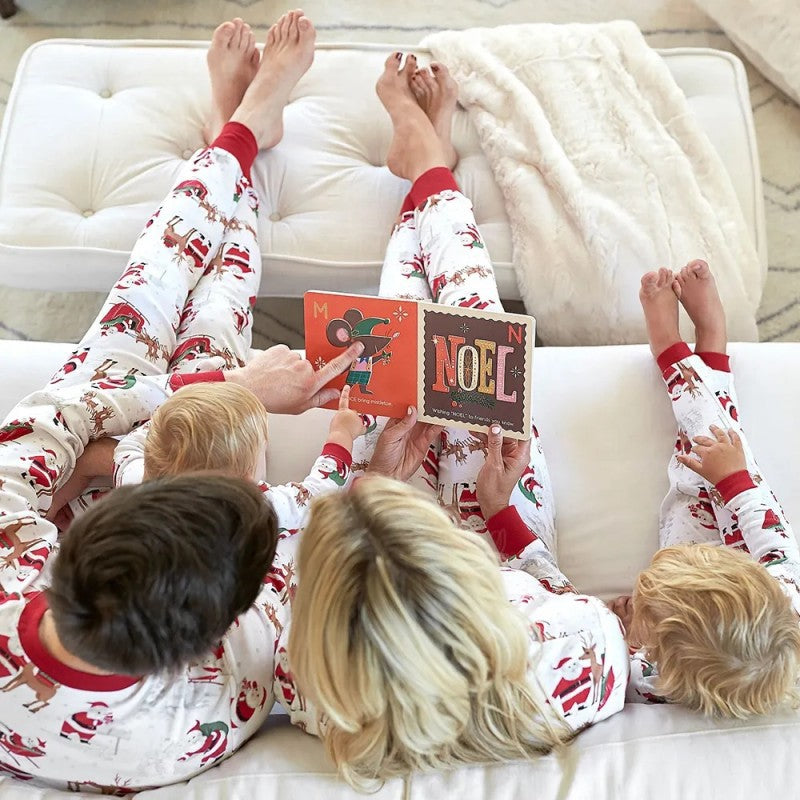 Family wearing matching white Christmas pajamas with Santa sleigh and reindeer print and red trim - view 9