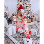 Matching family Christmas pajamas with red reindeer and snowflake print