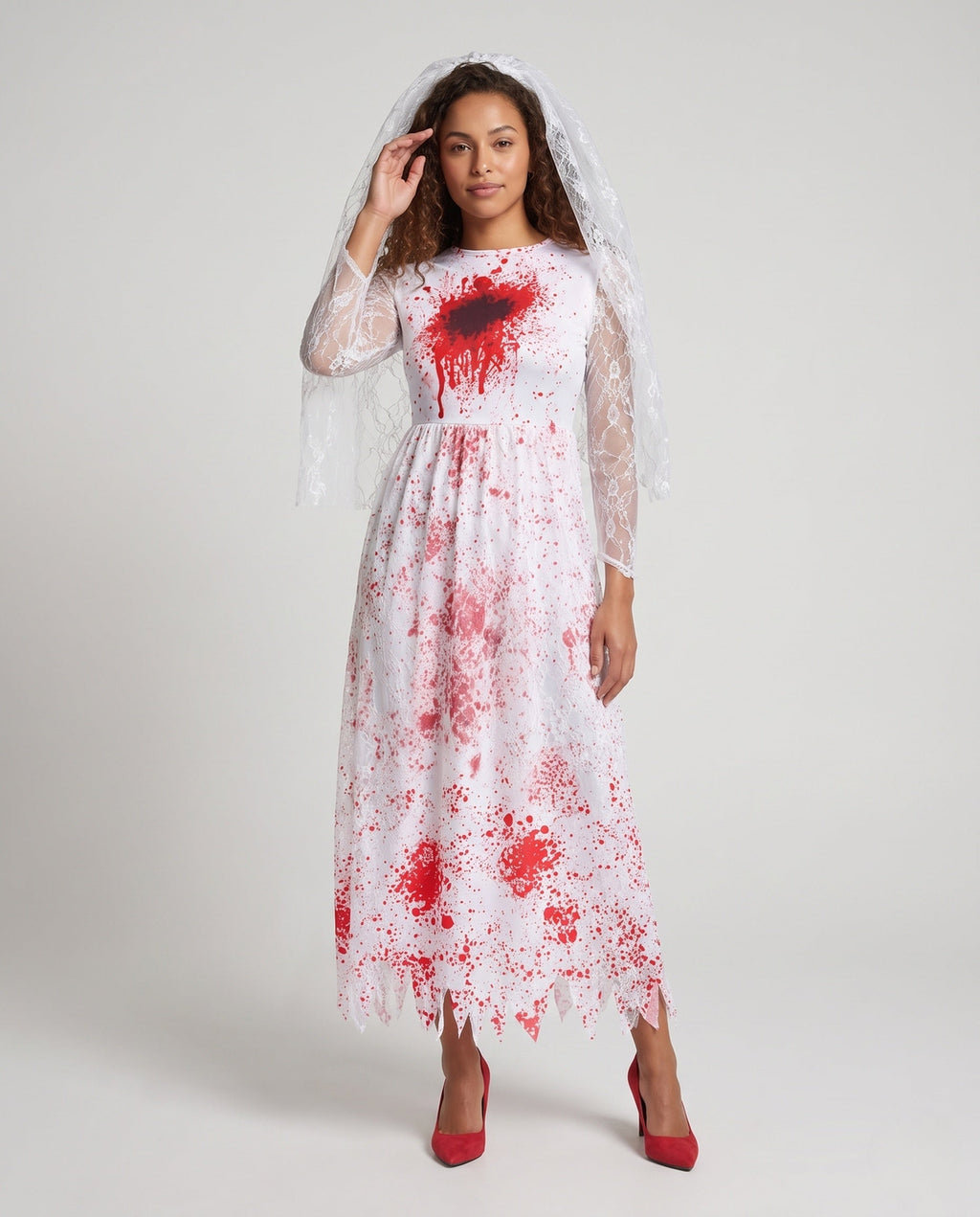 Woman wearing a bloody bride Halloween costume dress with lace sleeves, jagged hem and sheer lace veil