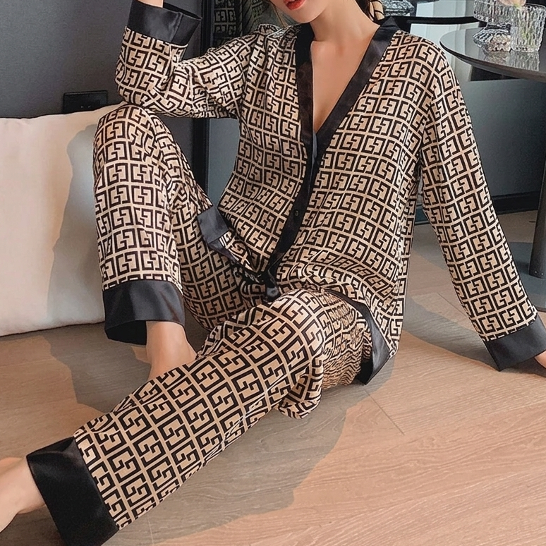 Women's geometric print satin pajama set with black contrast trim, V-neck button top and long sleeves