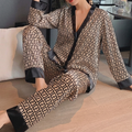 Women's geometric print satin pajama set with black contrast trim, V-neck button top and long sleeves