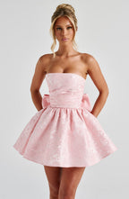 Strapless pink floral jacquard homecoming mini dress with oversized back bow and lace-up corset back