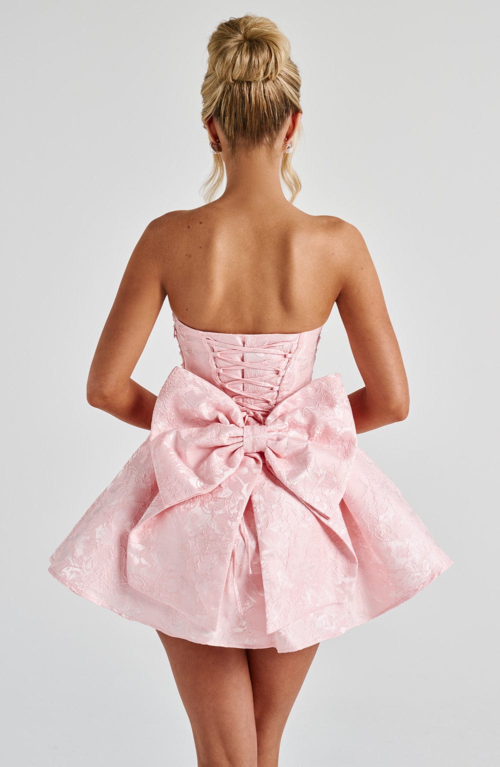 Strapless pink floral jacquard homecoming mini dress with oversized back bow and lace-up corset back - view 3