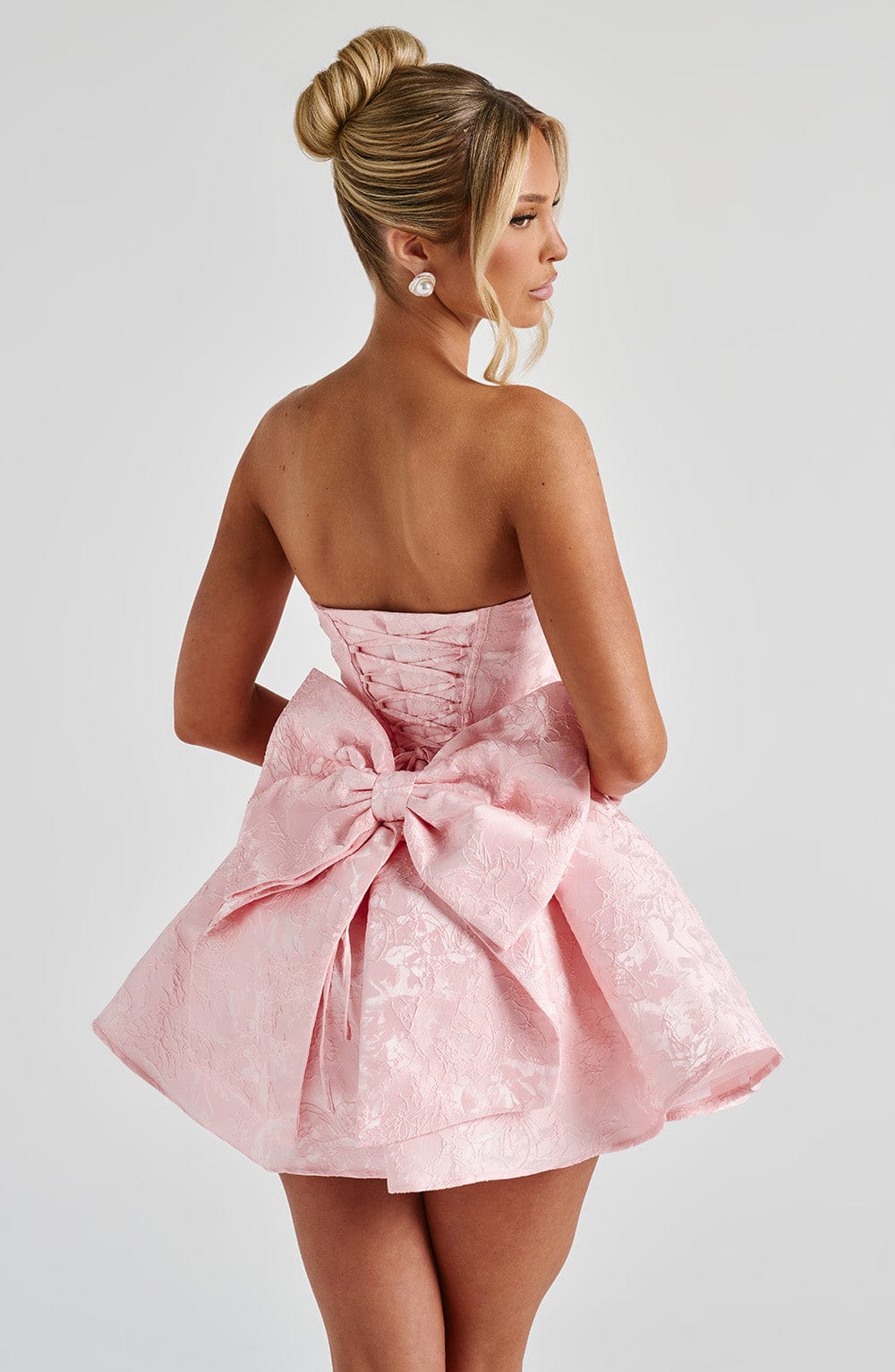 Strapless pink floral jacquard homecoming mini dress with oversized back bow and lace-up corset back - view 7