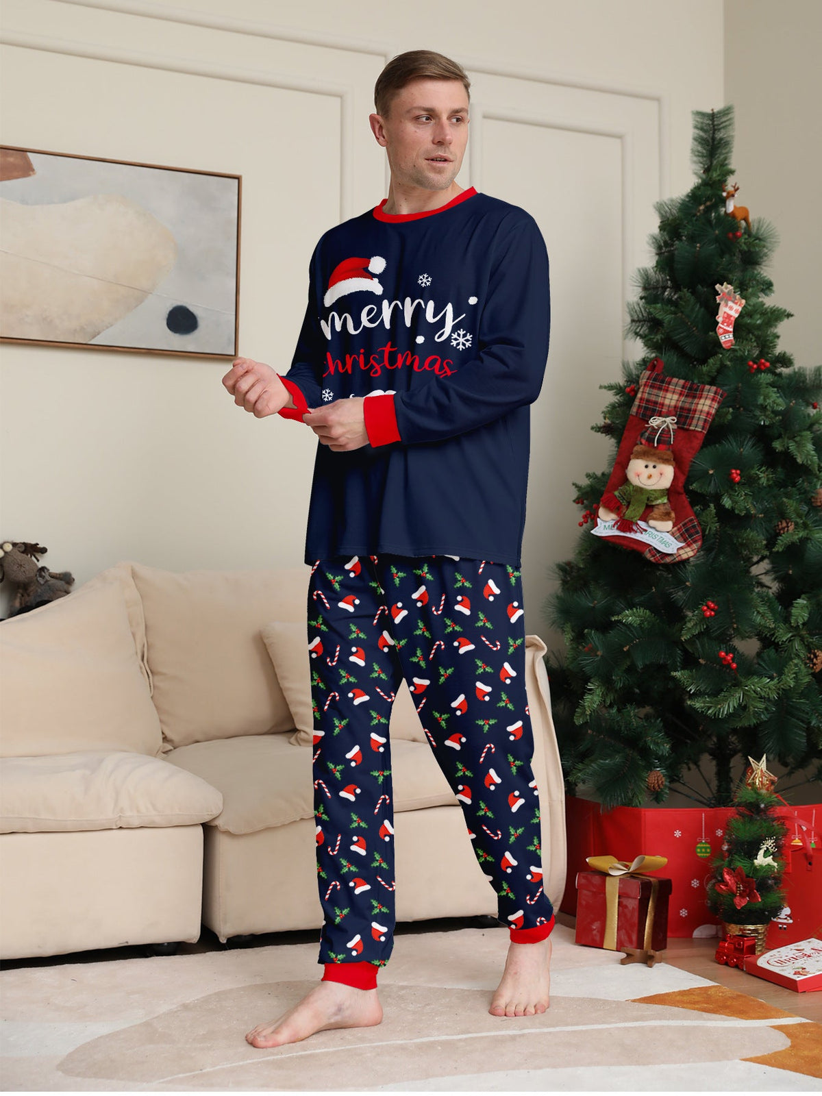 Matching family Christmas pajamas in navy with a Merry Christmas Santa hat top and holiday print pants - view 6