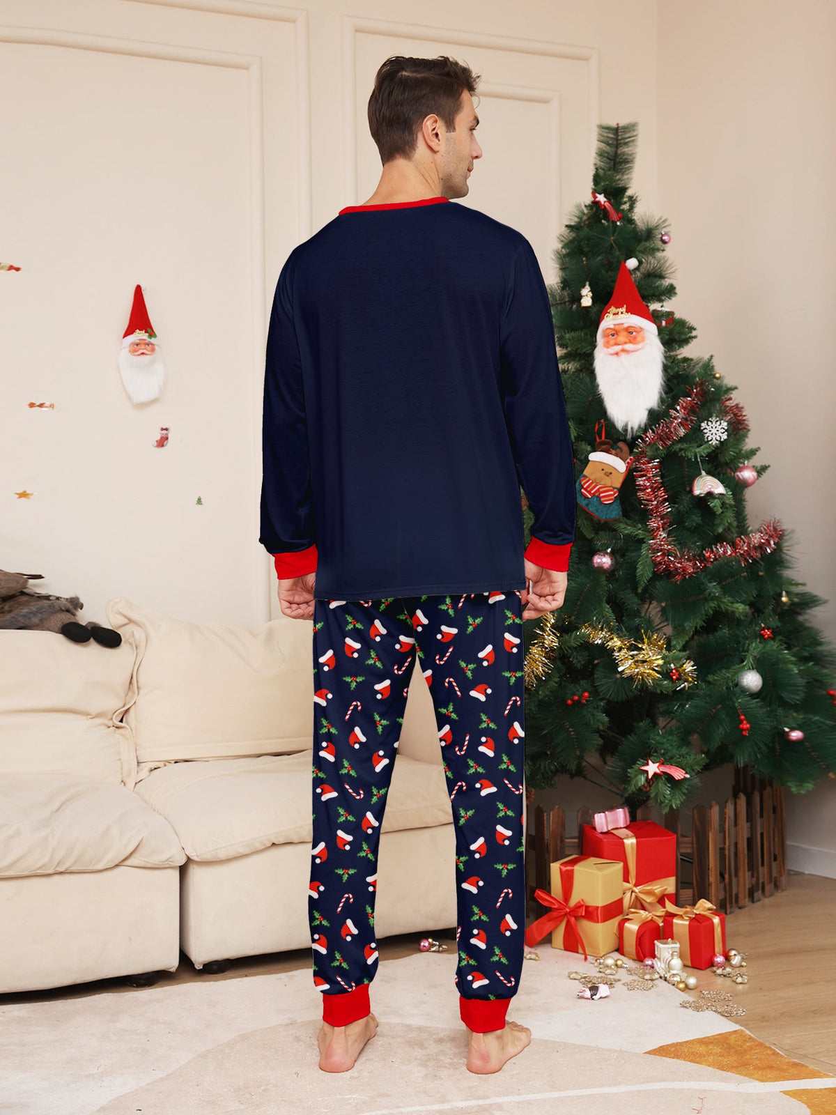 Matching family Christmas pajamas in navy with a Merry Christmas Santa hat top and holiday print pants - view 7