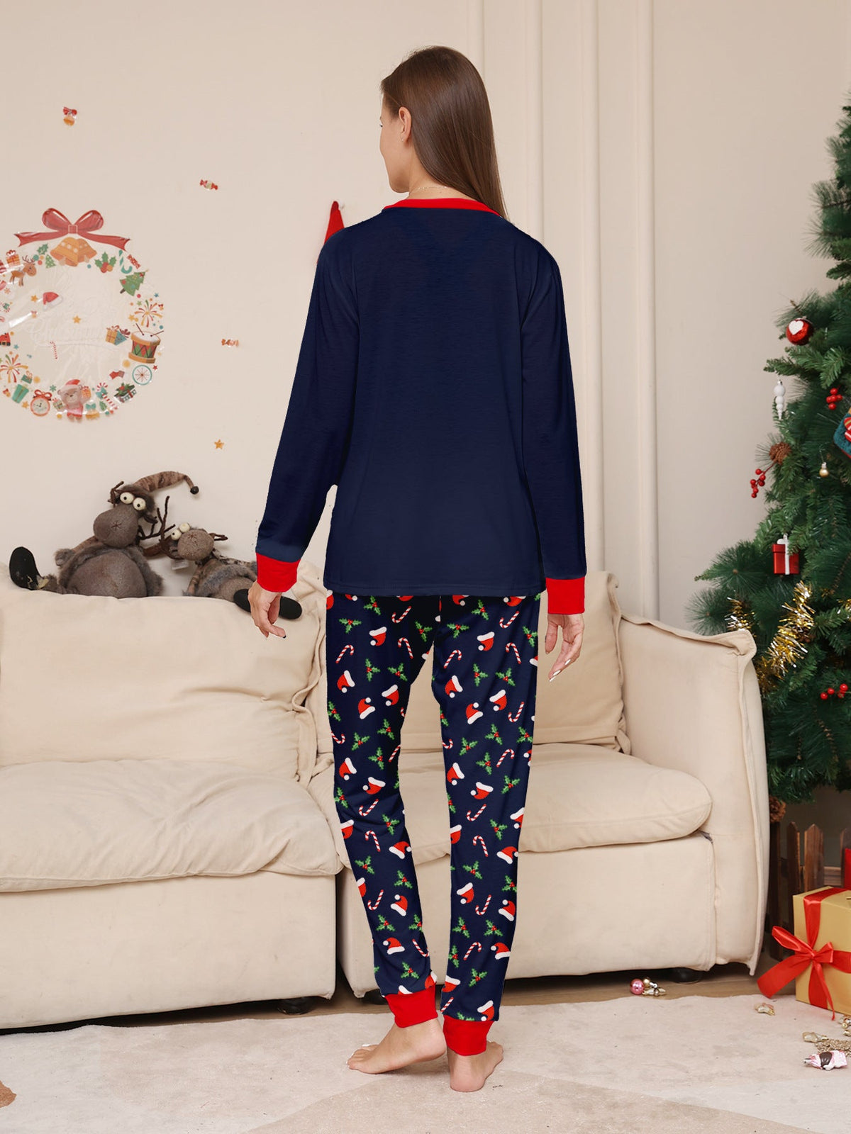 Matching family Christmas pajamas in navy with a Merry Christmas Santa hat top and holiday print pants - view 8
