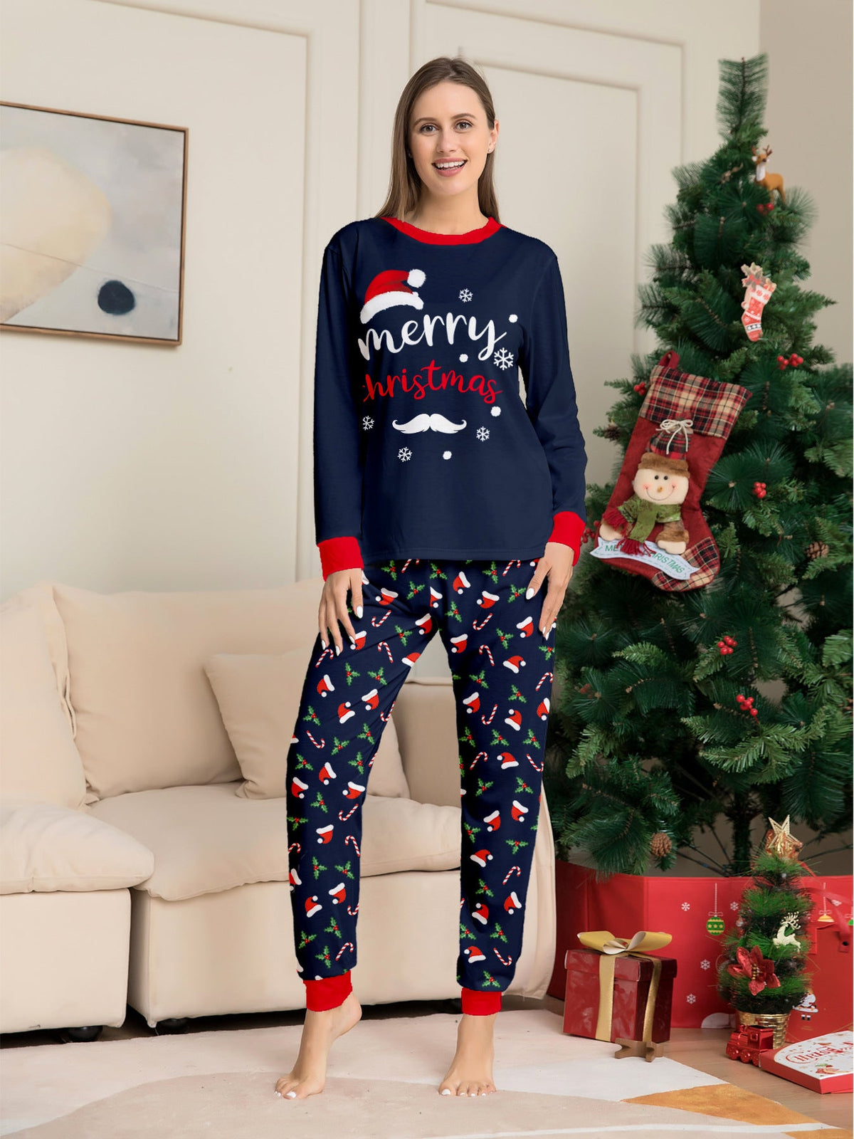 Matching family Christmas pajamas in navy with a Merry Christmas Santa hat top and holiday print pants - view 9