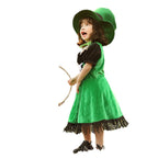 Girl wearing a green velvet leprechaun costume dress with lace-up front, black puff sleeves, fringed hem and tall buckled hat - view 5