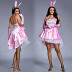 Woman wearing pink satin bunny costume with halter neck, white bib, ruffled tulle high-low skirt and bunny ears headband - view 4