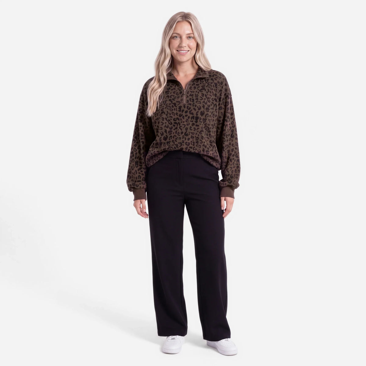 Woman wearing an oversized quarter zip sweatshirt in dark brown leopard print ribbed knit with black leggings - view 3