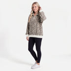 Woman wearing an oversized quarter zip sweatshirt in dark brown leopard print ribbed knit with black leggings - view 8