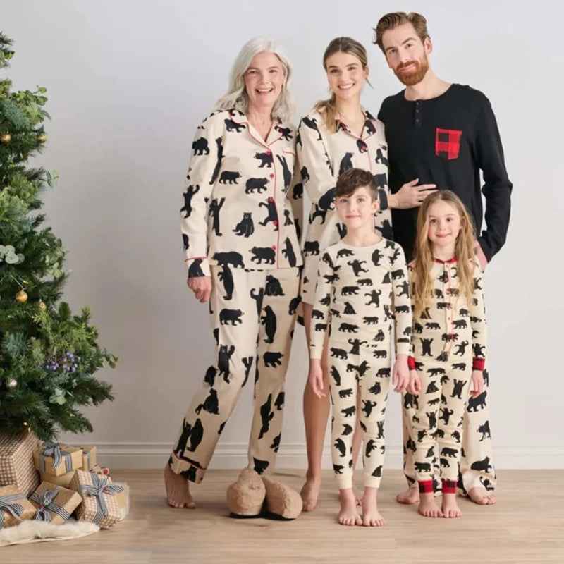 Matching Christmas pajamas with black bear print worn by a family by the tree - view 2