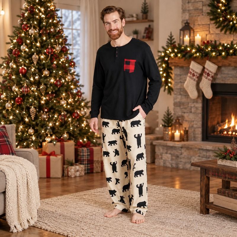 Matching Christmas pajamas with black bear print worn by a family by the tree - view 3