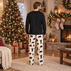 Matching Christmas pajamas with black bear print worn by a family by the tree - view 4