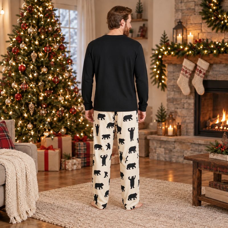 Matching Christmas pajamas with black bear print worn by a family by the tree - view 4