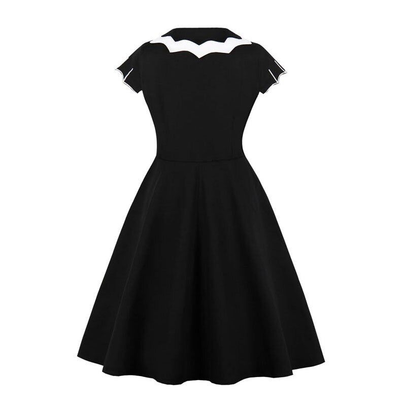 Black swing dress with white bat-shaped collar and embroidered bats on the skirt