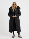 Model in a quilted hooded winter puffer jacket with self-tie belt