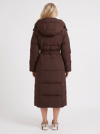 Model in a quilted hooded winter puffer jacket with self-tie belt - view 11