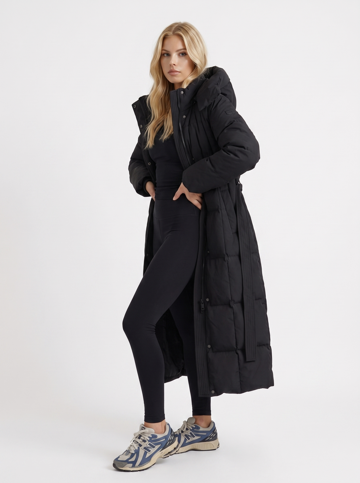 Model in a quilted hooded winter puffer jacket with self-tie belt - view 3