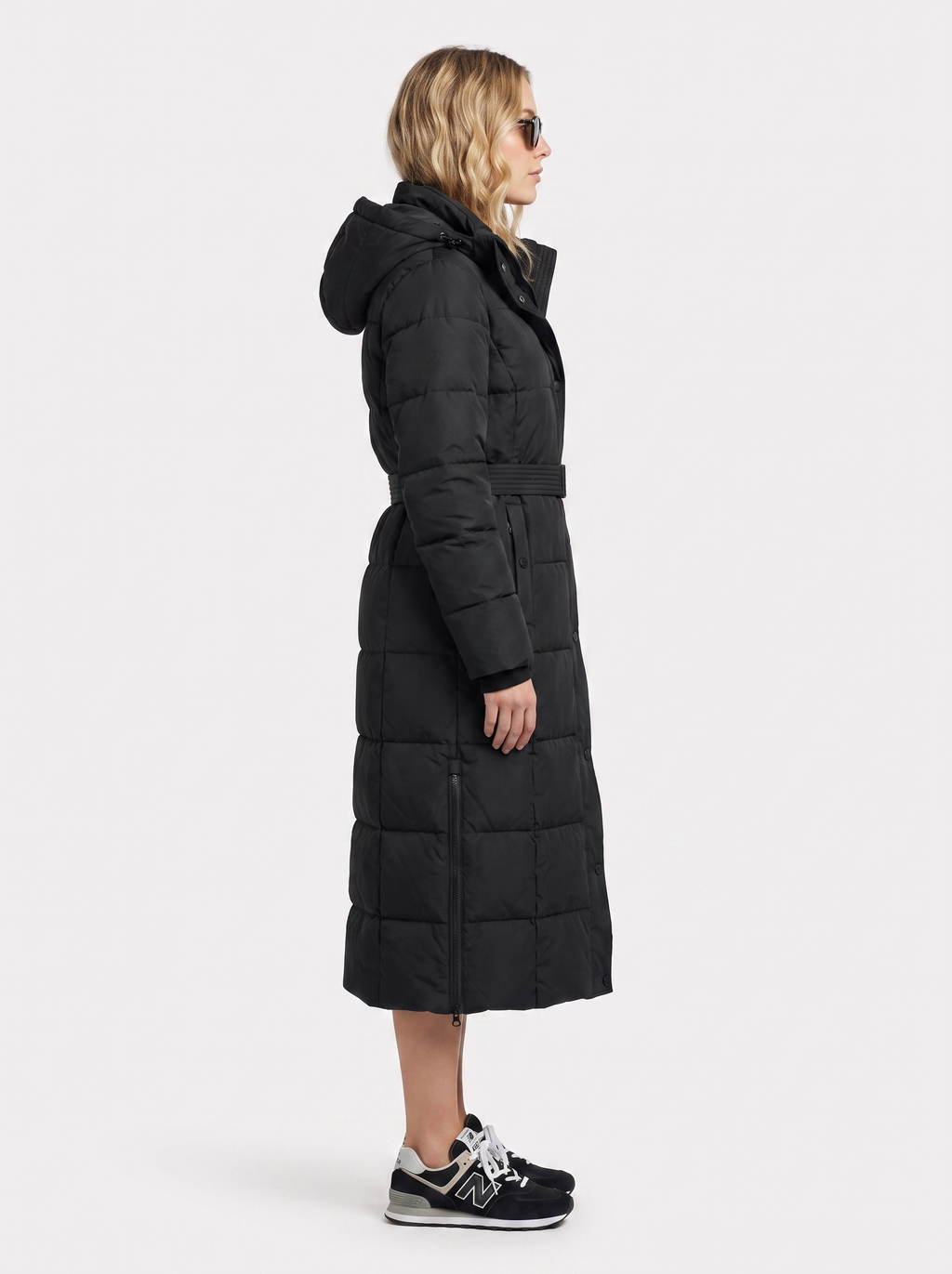 Model in a quilted hooded winter puffer jacket with self-tie belt - view 4