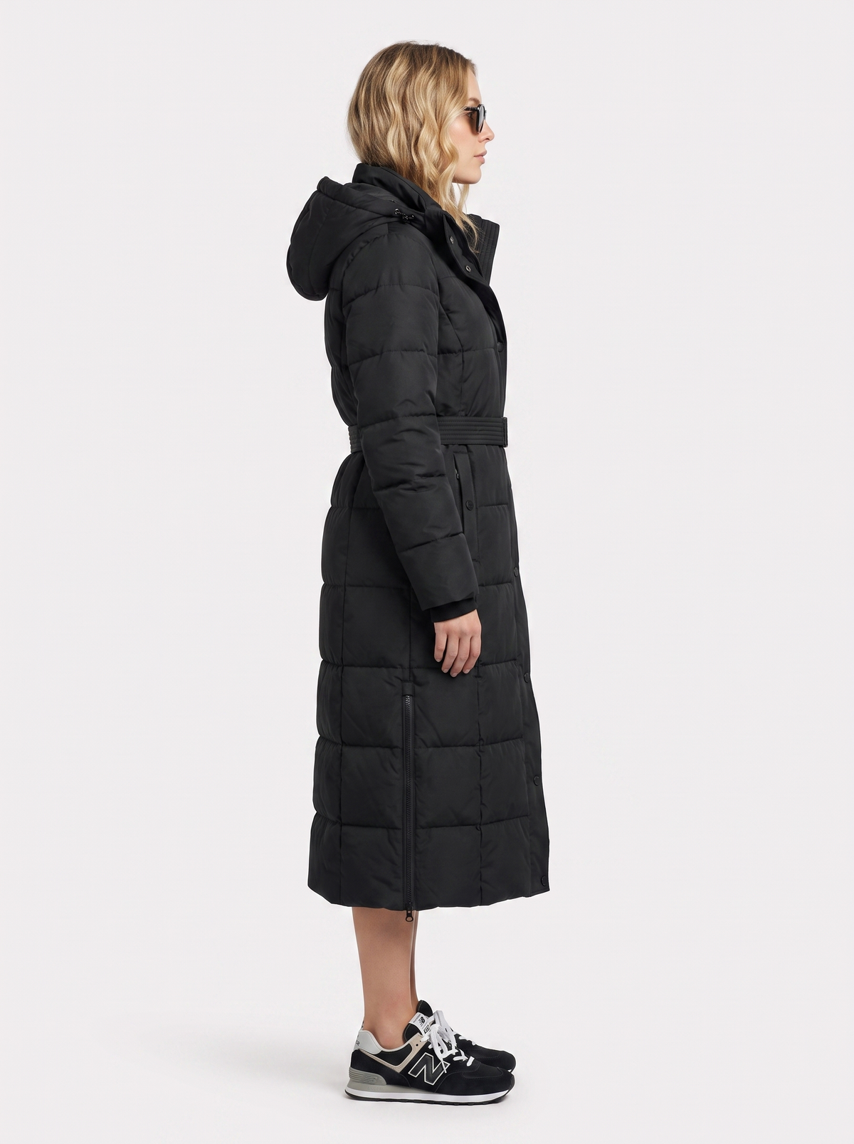 Model in a quilted hooded winter puffer jacket with self-tie belt - view 4