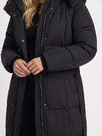 Model in a quilted hooded winter puffer jacket with self-tie belt - view 6