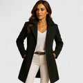 Woman wearing a double-breasted long coat with notched lapels, a tailored womens coat in black, gray and camel