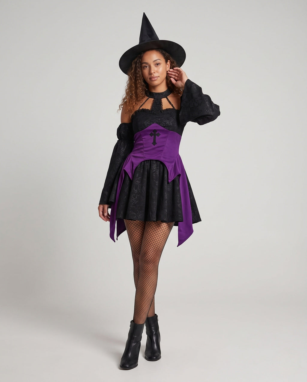 Black jacquard witch costume mini dress with purple corset-style waist, cross appliqué and off-the-shoulder bell sleeves
