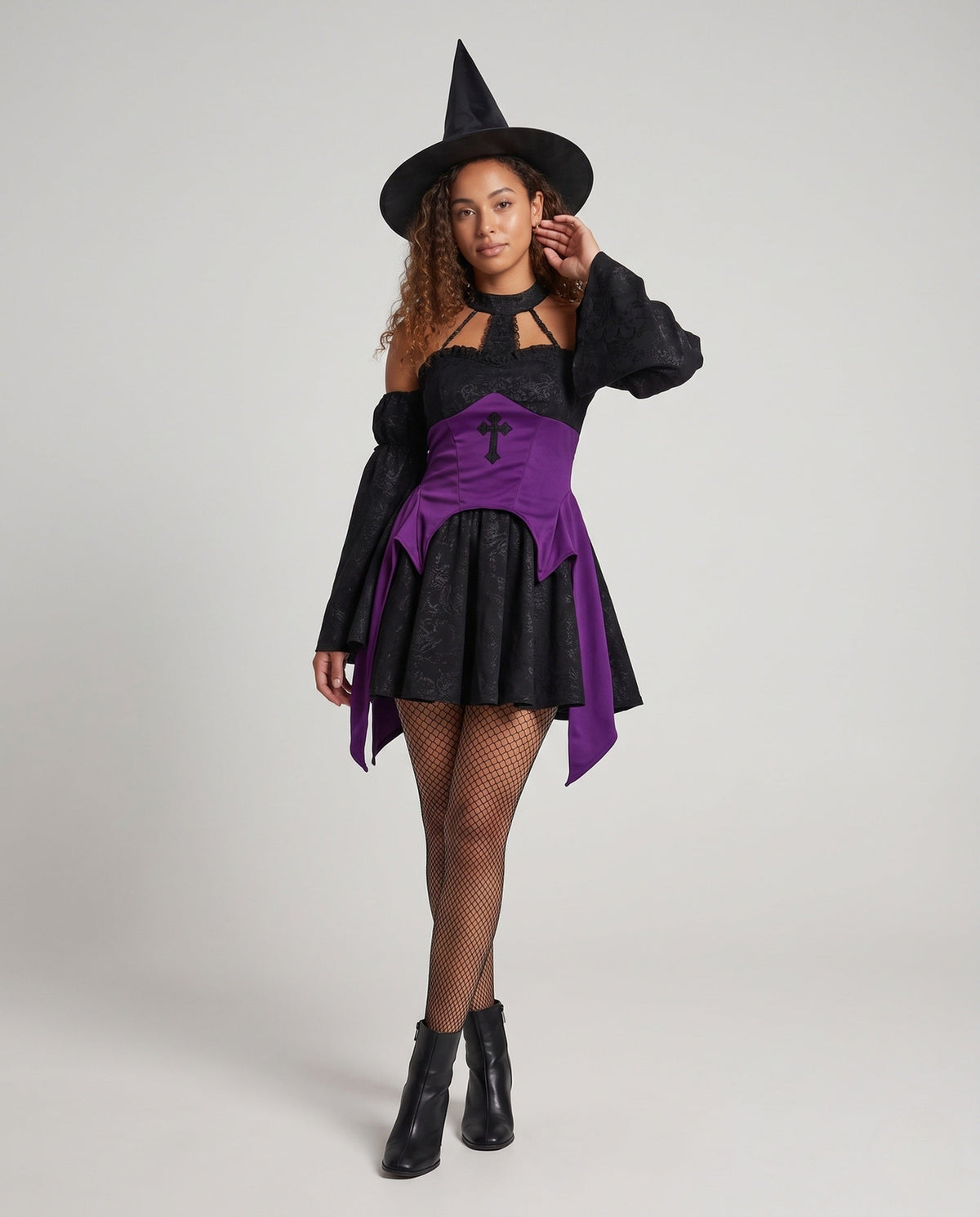 Black jacquard witch costume mini dress with purple corset-style waist, cross appliqué and off-the-shoulder bell sleeves