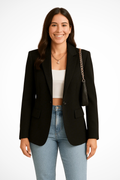 Women's tailored single-button blazer with notch lapels and flap pockets worn with jeans