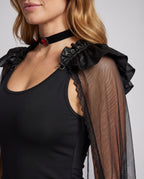 Women's black Halloween costume dress with sheer tulle cape, ruffled shoulders and satin bow sash - view 2