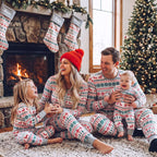 Matching family Christmas pajamas with red and green reindeer and snowflake print and gray ribbed cuffs - view 3