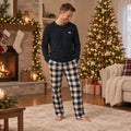 Matching Christmas pajamas with polar bear print tops and black and cream plaid pants - view 2