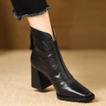 Black leather ankle boots with block heel, pointed toe and back zip, worn with cropped jeans