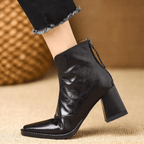Black leather ankle boots with block heel, pointed toe and back zip, worn with cropped jeans - view 2